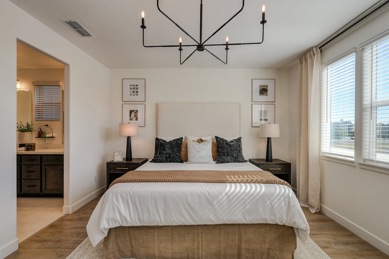 A stylish bedroom with contemporary decor and natural lighting.